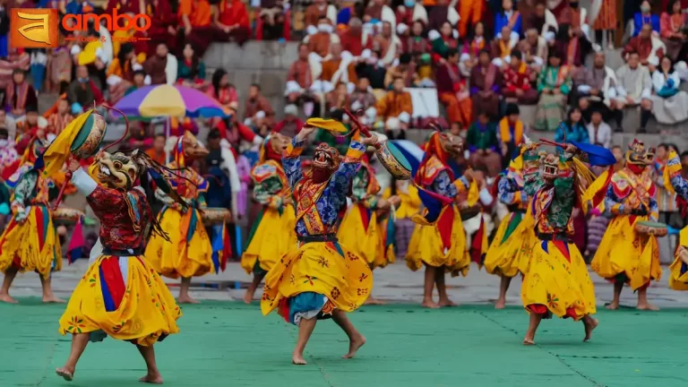 Monks performing sacred Cham masked dances at the Punakha Tshechu festival at Punakha Dzong, at the confluence of the Pho Chhu and Mo Chhu rivers, Bhutan